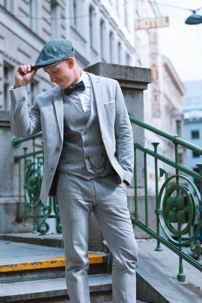 Urban sophistication: A stylish man enhances his look with a classic flat cap