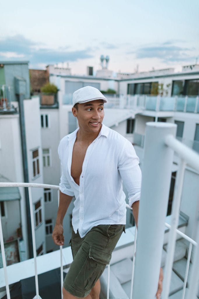 Timeless elegance: A stylish man adds flair to his outfit with a flat cap