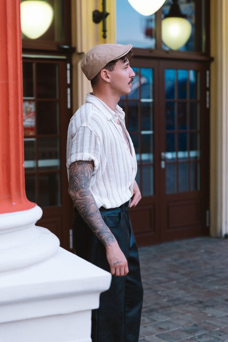 Modern flat cap finesse: A stylish youth elevates his urban style