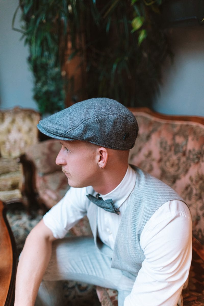 A man's flat cap choice encapsulates his unique blend of classic and contemporary style